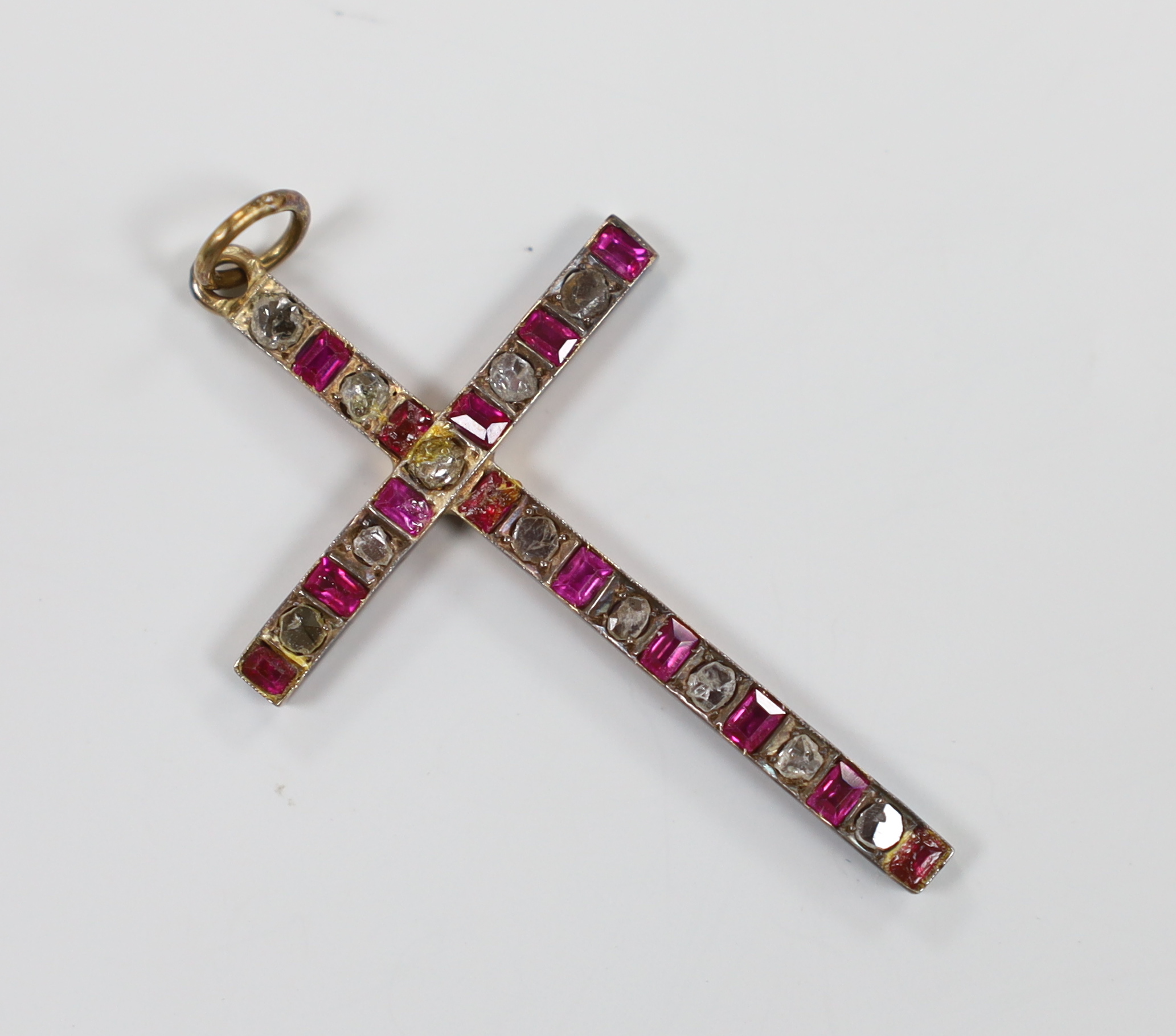 An early 20th century yellow metal, flat cut diamond and ruby set cross pendant, 45mm, gross weight 3.3 grams